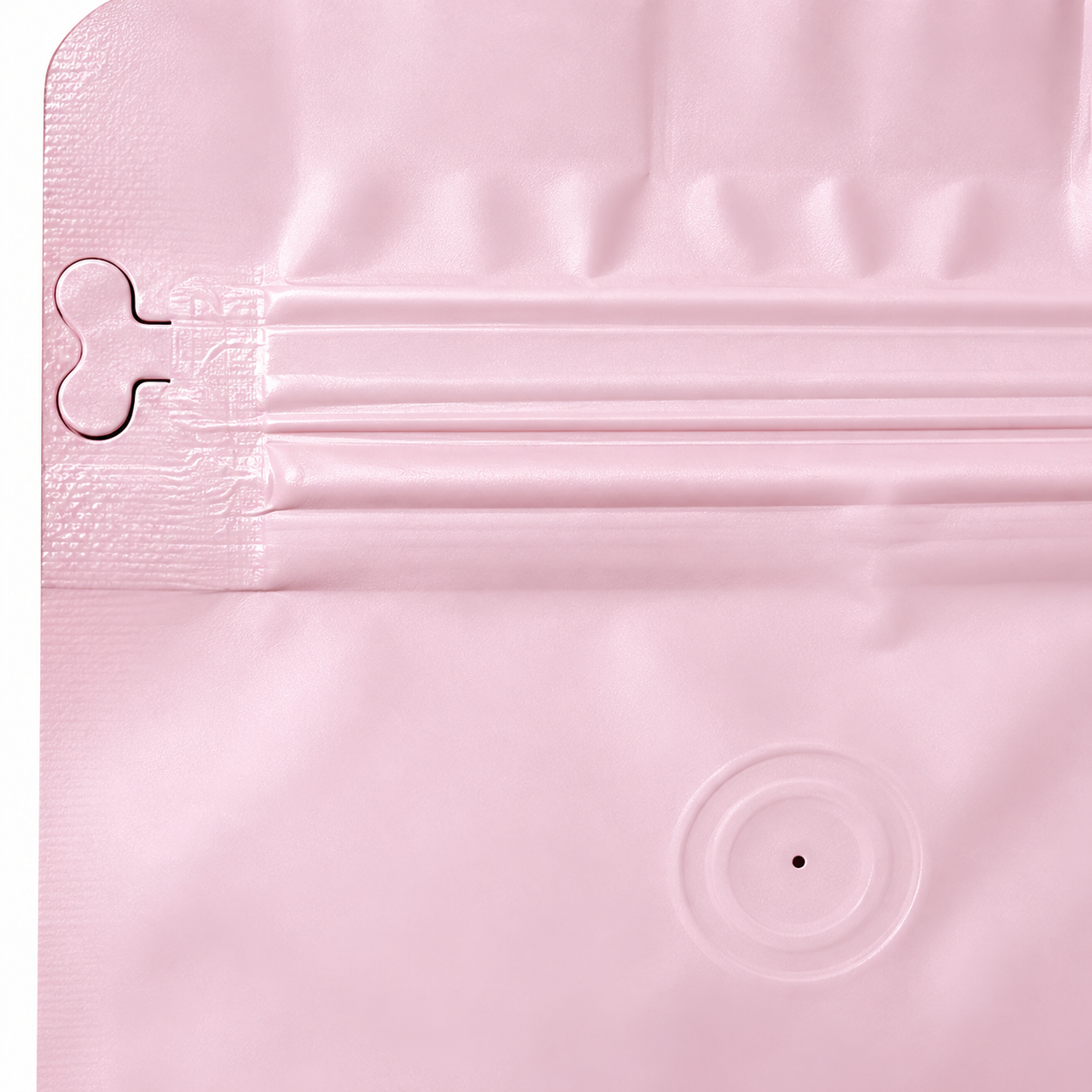 Closeup of the resealable zipper and one-way degassing valve on the pink coffee bag